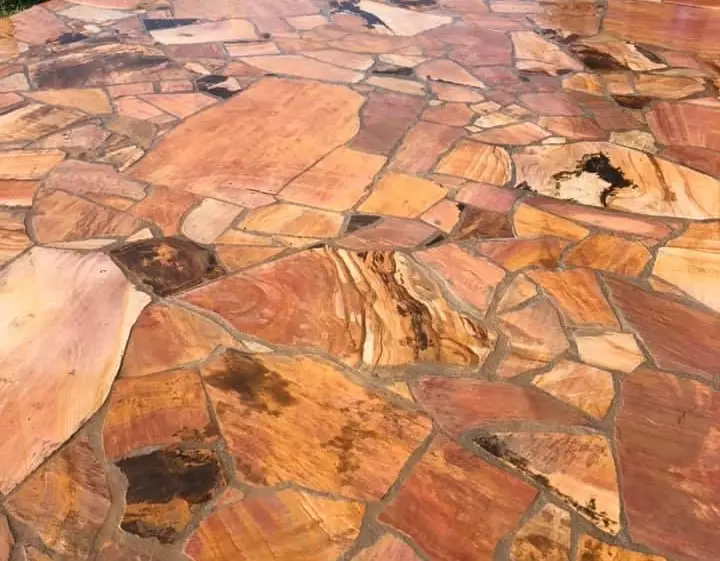 a flagstone sourced from Arizona, U.S. with many tans and reds installed on an outdoor patio